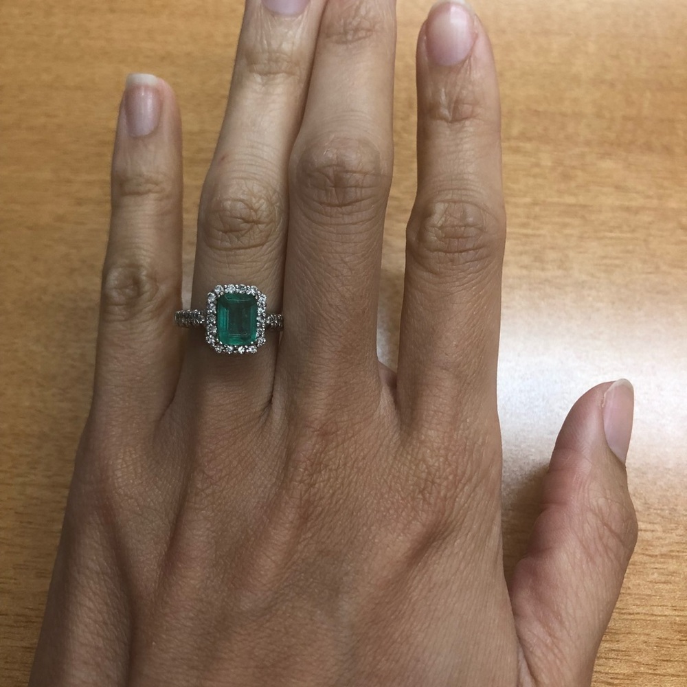emerald and diamond halo ring in 14k white gold